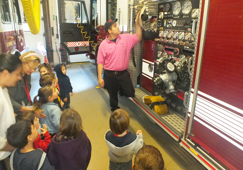 Preschoolers listening to the fireman talk about fire safety 