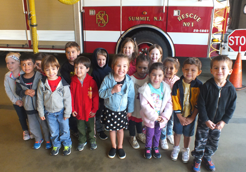 Preschool class photo in front of the fire truck 