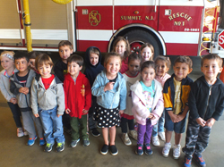 Preschool class photo in front of the fire truck